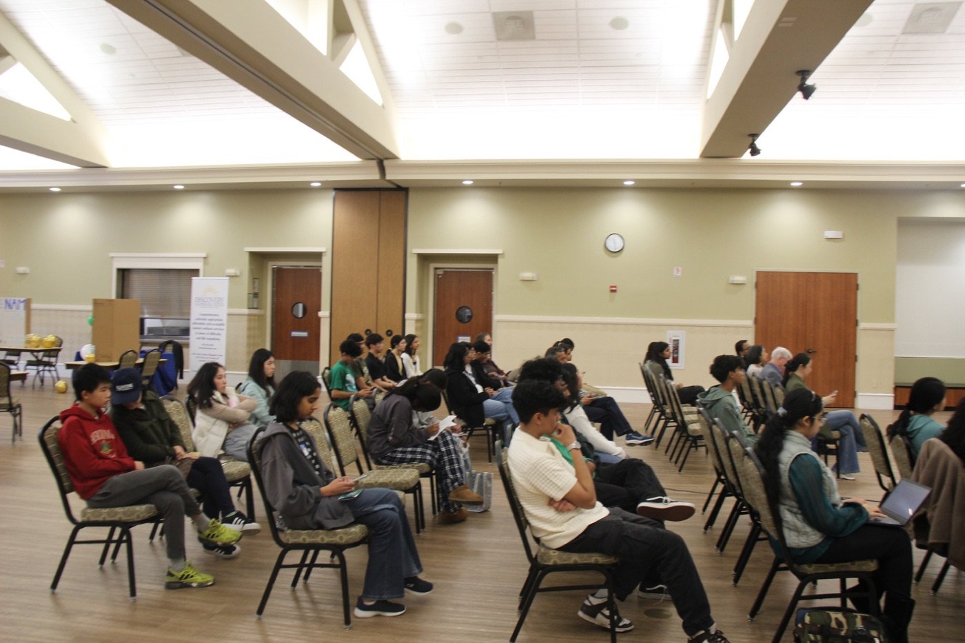 Students seated at an NHA community event