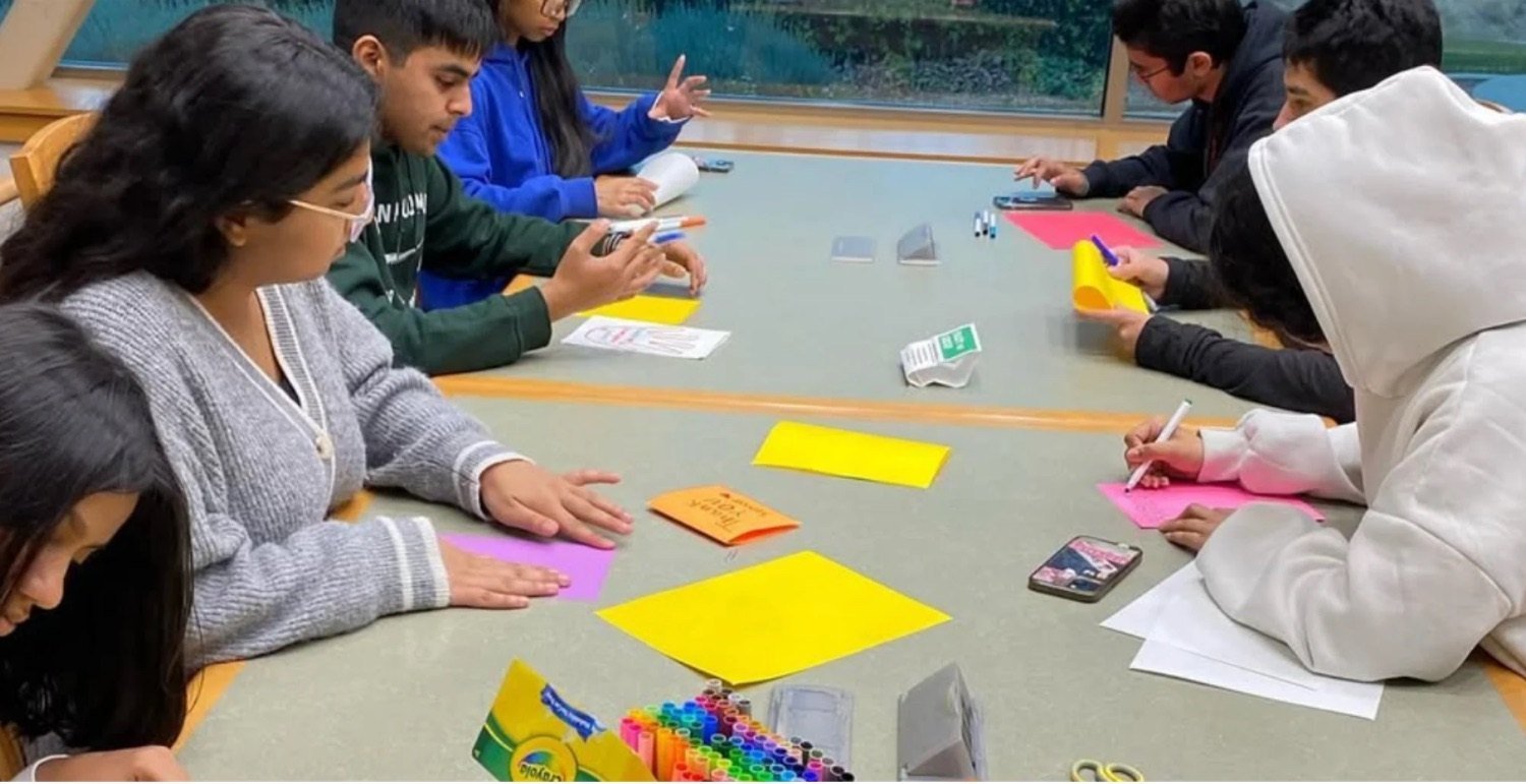 Students writing affirmation cards at an NHA workshop