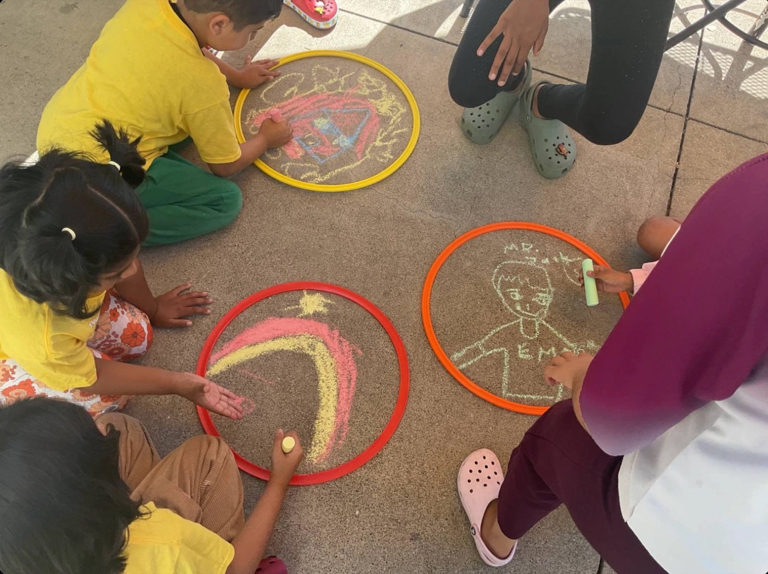 Kids drawing with chalk at an NHA community event