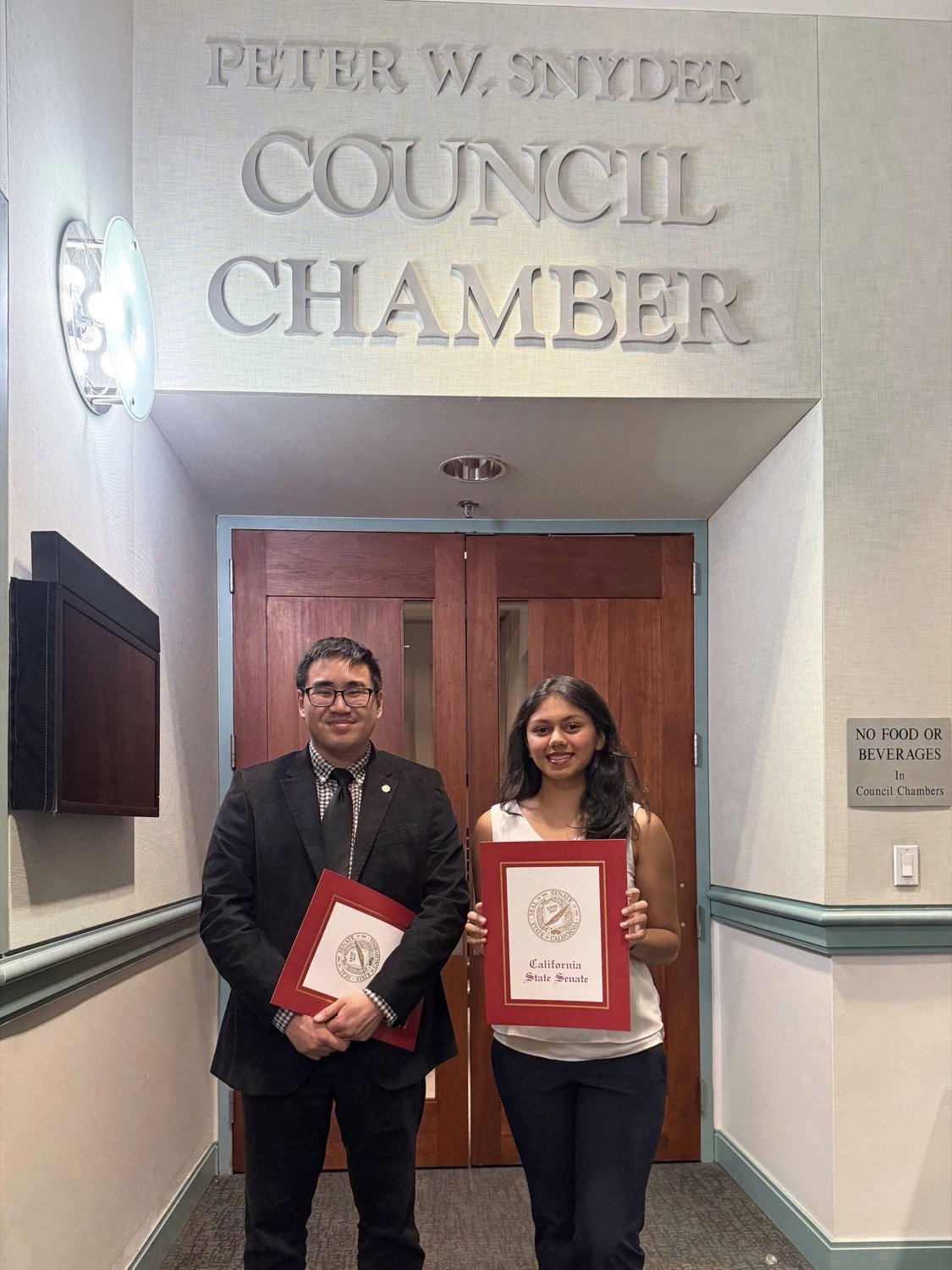 Suhani Gupta with a California State Senate certificate at the council chamber