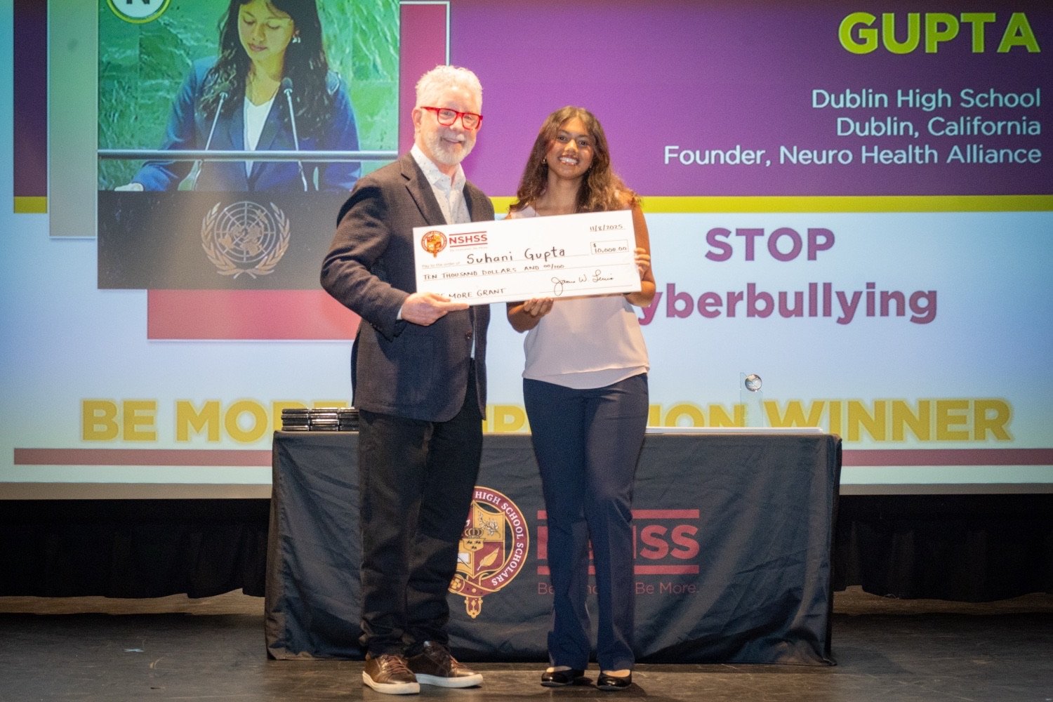 Suhani Gupta accepting the NSHSS Be More Grant for STOP-Cyberbullying